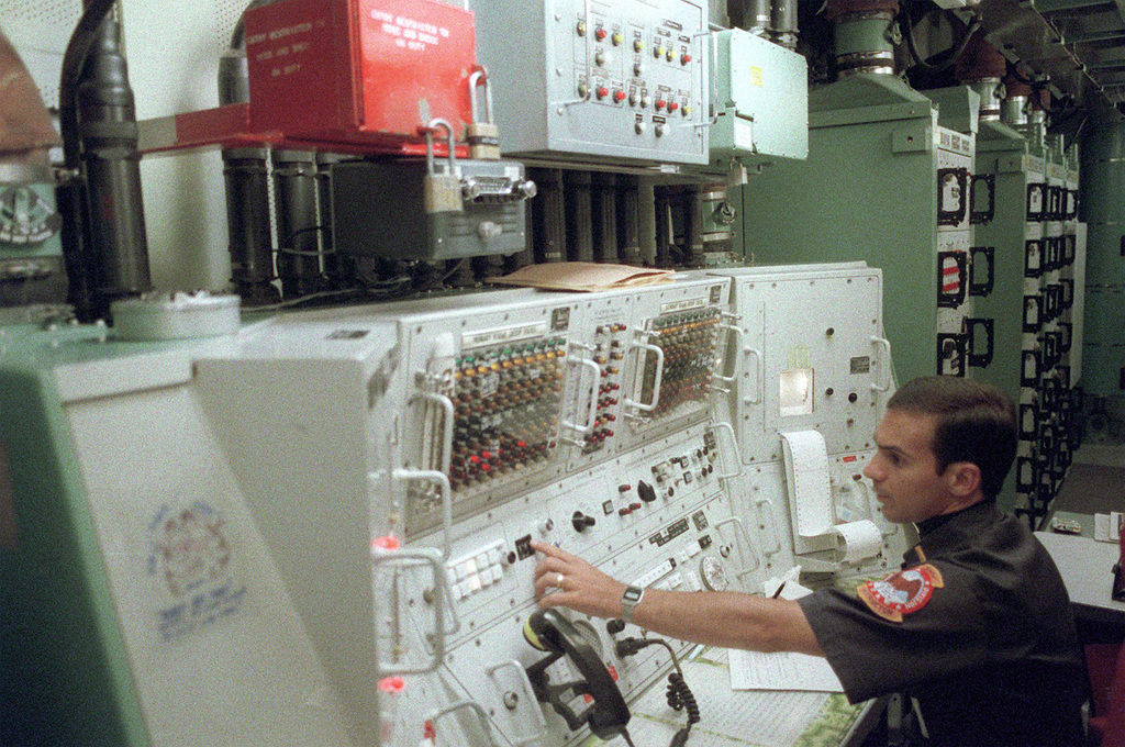 A member of the 321st Strategic Missile Wing works at a control panel inside a Minuteman III intercontinental ballistic missile silo