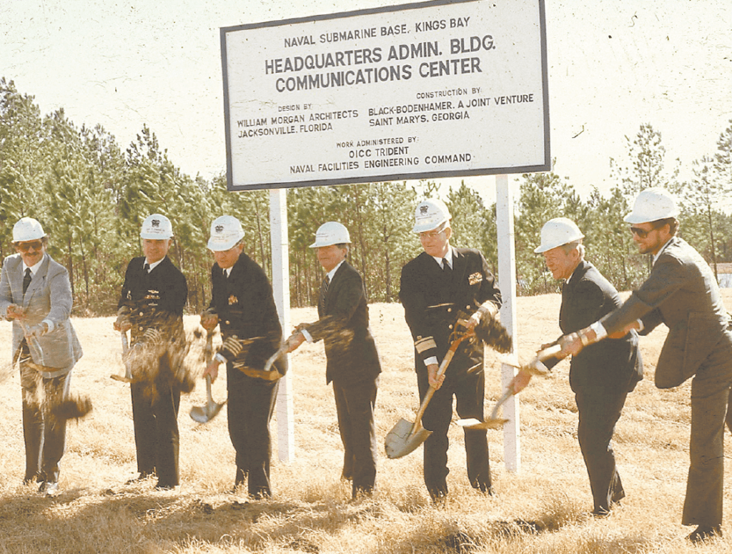 Civilians and Sailors break ground near an open field where the Headquarters Building at Fluckey Hall is today.