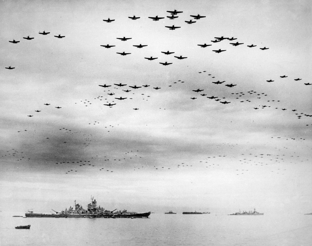 U.S. Navy carrier planes fly in formation over the U.S. and British fleets in Tokyo Bay