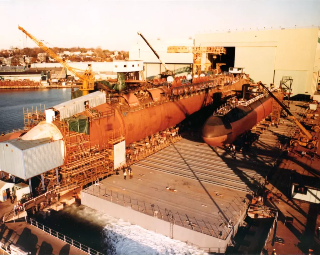 USS Ohio (SSBN 726) under construction. A smaller attack submarine can be seen beside her.