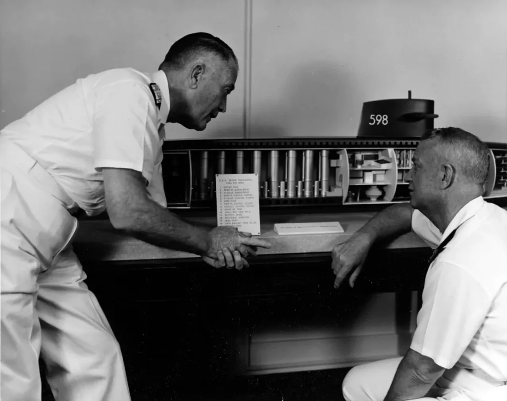 In July 1959, Rear Admiral William F. Rayborn, USN (left), and Admiral Arleigh A. Burke, USN, Chief of Naval Operations, inspect a cutaway model of the ballistic missile submarine USS George Washington (SSBN-598).
