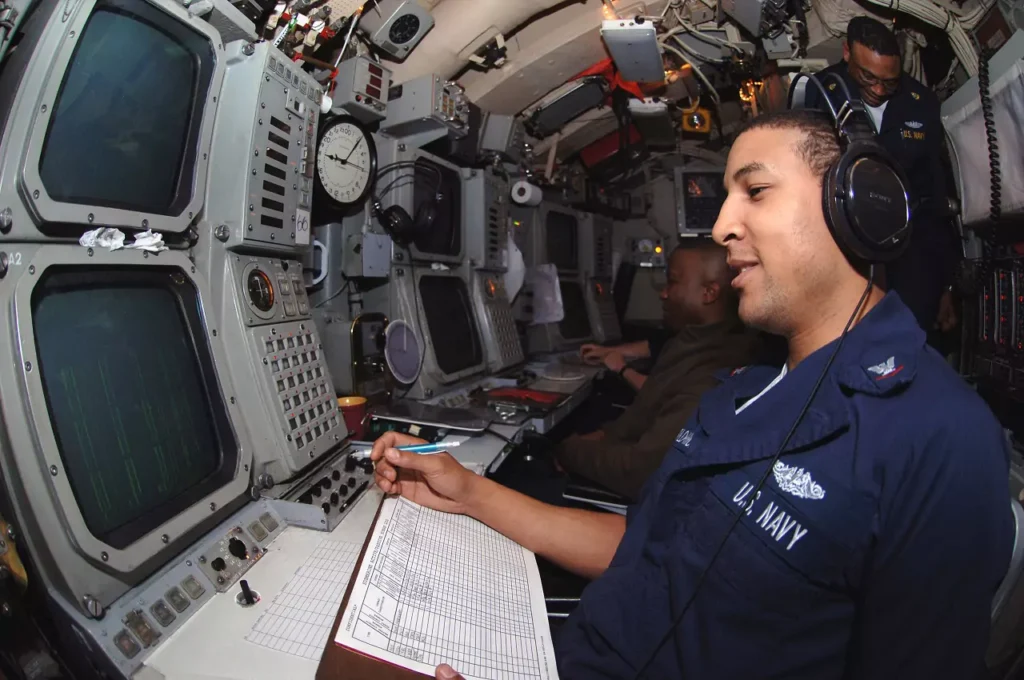 A crew member operating the broad-band sonar aboard the USS Ohio