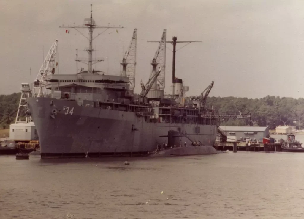USS John Adams (SSBN-620) docked side by side with submarine tender USS Canopus (AS-34) at Naval Weapons Station, Charleston, South Carolina in 1980.